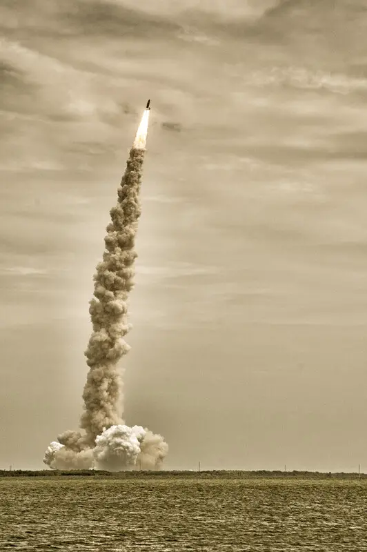 sepia photo rocket launching into the air with long trail of exhaust to represent launching your affiliate business