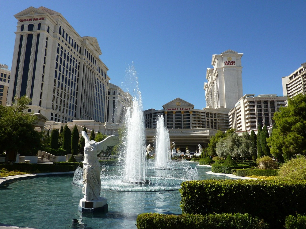 The photo shows the outside of the Caesars Palace Hotel capturing the fountains and statues surrounding the Las Vegas Hotel.