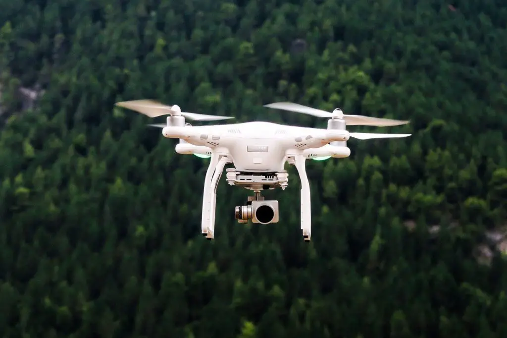 a drone flying over a forest to represent drone affiliate programs