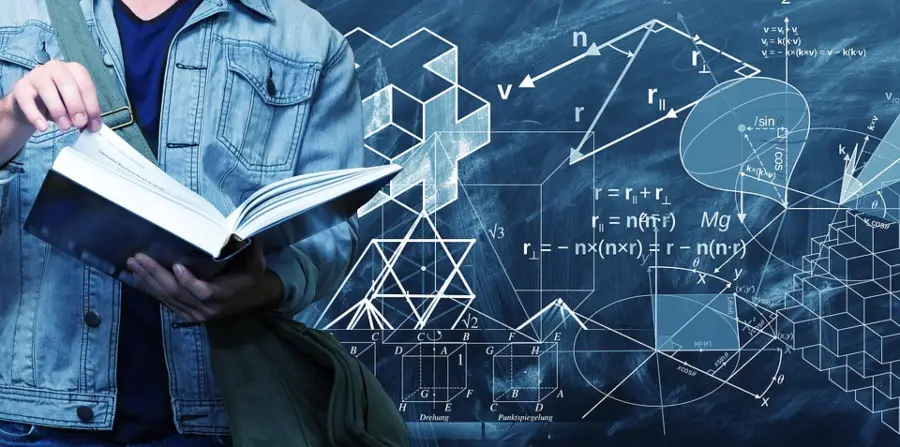 Image shows a student studying a textbook with a blackboard in the background showing various STEM (science, technology, engineering and math) equations, formulas and diagrams.