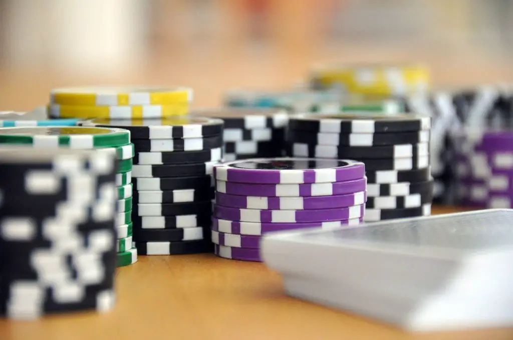 several different colors of poker chips on a table to represent casino affiliate programs